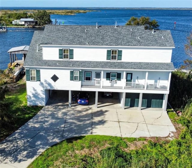 exterior space featuring a carport, a water view, and a balcony