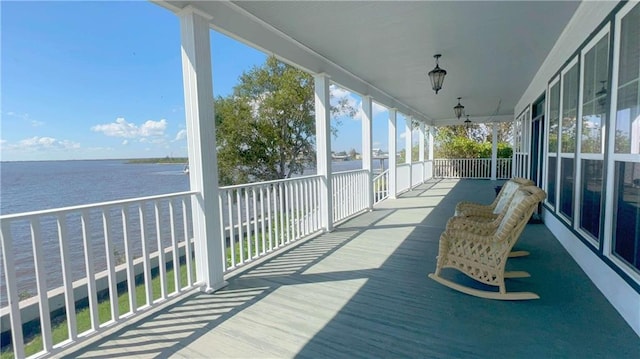 sunroom / solarium with a water view