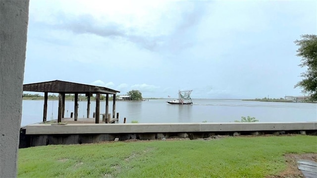 dock area with a water view and a lawn