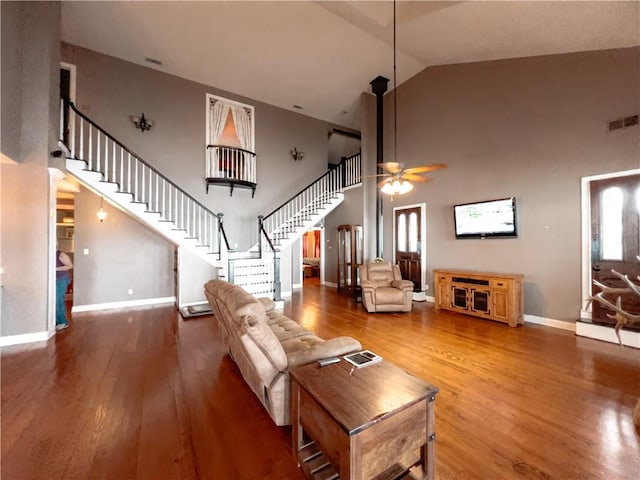 living room featuring ceiling fan, high vaulted ceiling, and hardwood / wood-style flooring