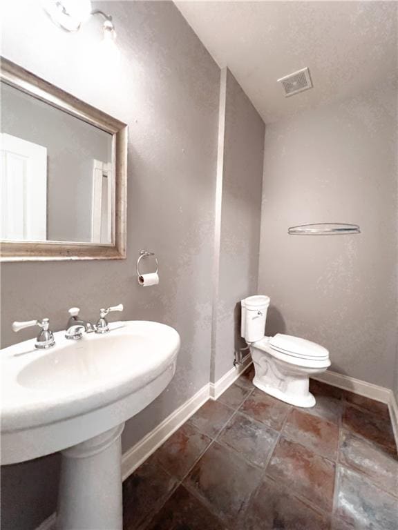 bathroom with toilet and sink