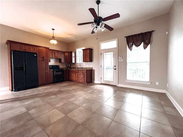 kitchen featuring pendant lighting, ceiling fan, sink, and black appliances