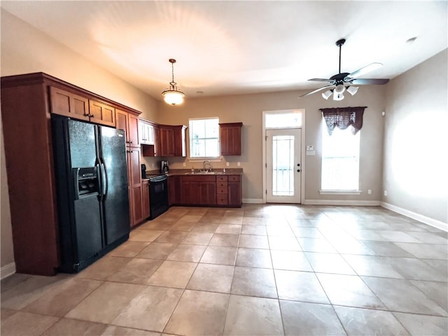 kitchen featuring light tile patterned floors, sink, ceiling fan, and black appliances