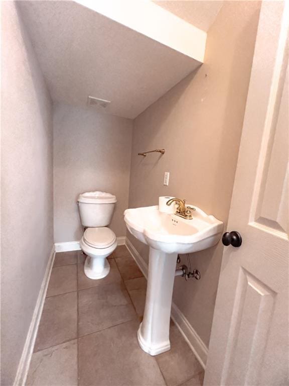 bathroom featuring tile patterned flooring and toilet