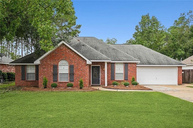 single story home featuring a garage and a front lawn