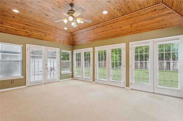 unfurnished sunroom with wooden ceiling, lofted ceiling, plenty of natural light, and ceiling fan