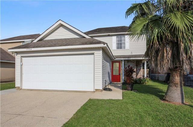 view of front of house with a front yard and a garage