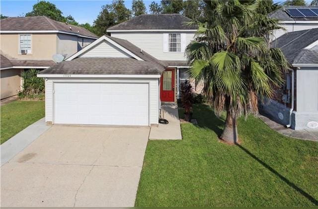 view of front of property with a front lawn and a garage