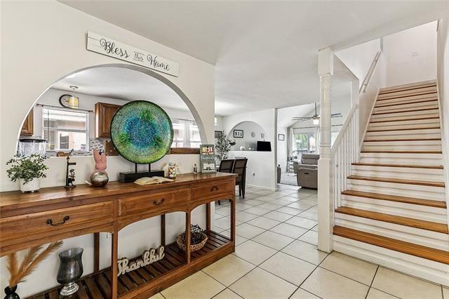 hall with a wealth of natural light and light tile patterned flooring