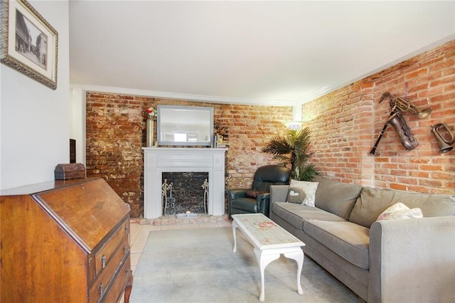 tiled living room with a brick fireplace, ornamental molding, and brick wall