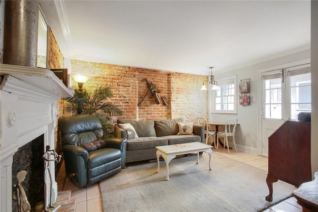 living room with ornamental molding, light tile patterned floors, and brick wall