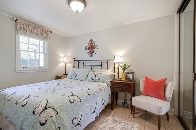 bedroom with a closet and light tile patterned flooring