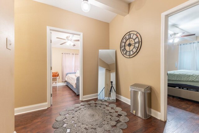 hallway featuring beamed ceiling and dark hardwood / wood-style floors