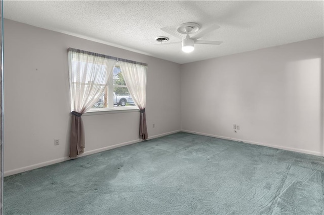 carpeted spare room featuring a textured ceiling and ceiling fan