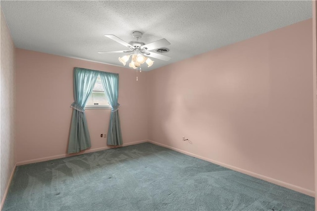 spare room with ceiling fan, a textured ceiling, and carpet floors