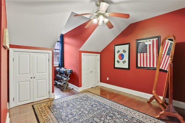 interior space featuring ceiling fan, light wood-type flooring, and lofted ceiling