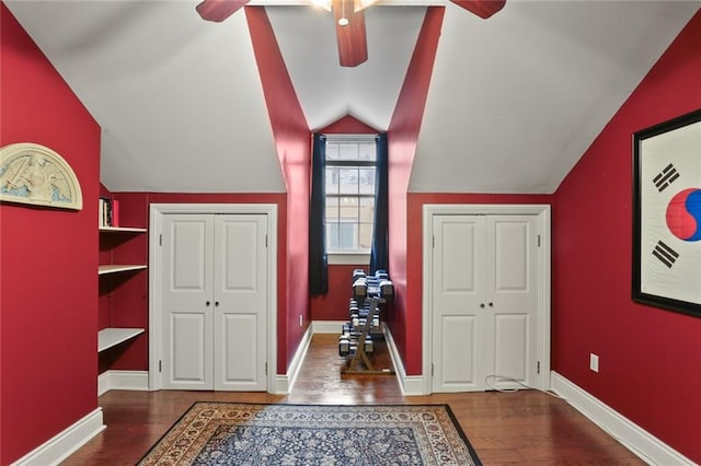 interior space with lofted ceiling, ceiling fan, and dark hardwood / wood-style flooring