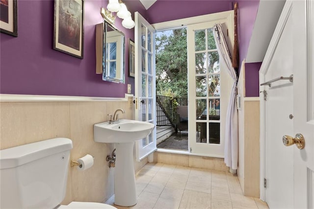 bathroom with tile patterned flooring and toilet