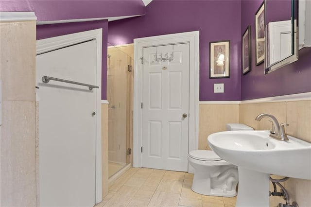 bathroom with toilet and an enclosed shower