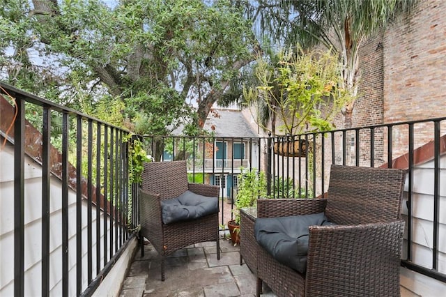 balcony with a patio area and an outdoor hangout area