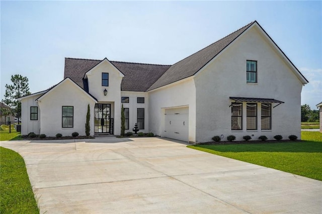 view of front of property featuring a garage and a front yard