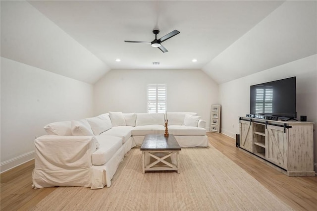 living room featuring light hardwood / wood-style floors, ceiling fan, and lofted ceiling