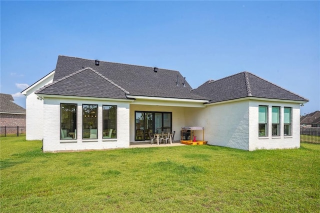 back of property featuring a patio area and a lawn