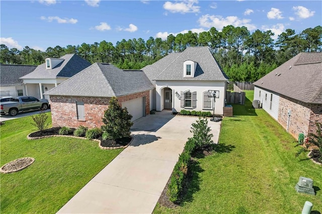 french country home featuring a garage and a front yard