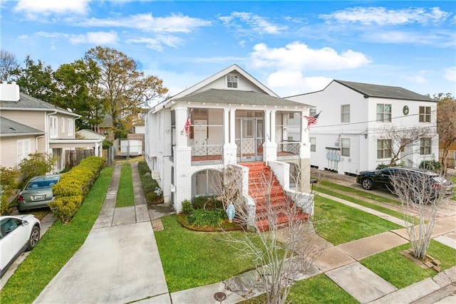 119 Elmeer Ave, Metairie, LA 70005 - shotgun-style home featuring brick siding, stairway, and a front lawn