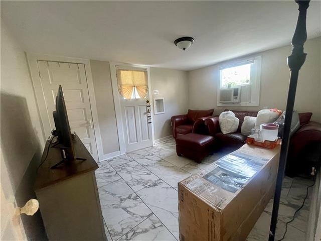 119 Elmeer Ave, Metairie, LA 70005 - living room with light marble finish flooring and cooling unit
