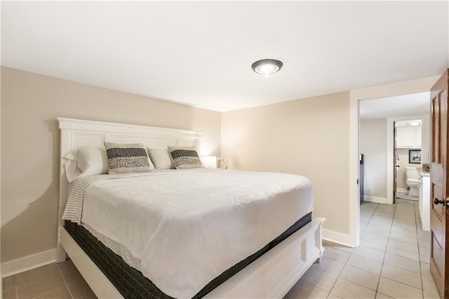 bedroom with ensuite bath and light tile patterned floors