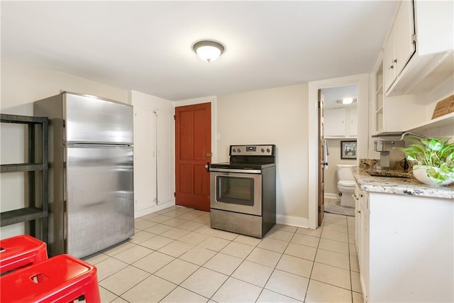 119 Elmeer Ave, Metairie, LA 70005 - kitchen with stainless steel appliances, light countertops, light tile patterned floors, open shelves, and white cabinetry
