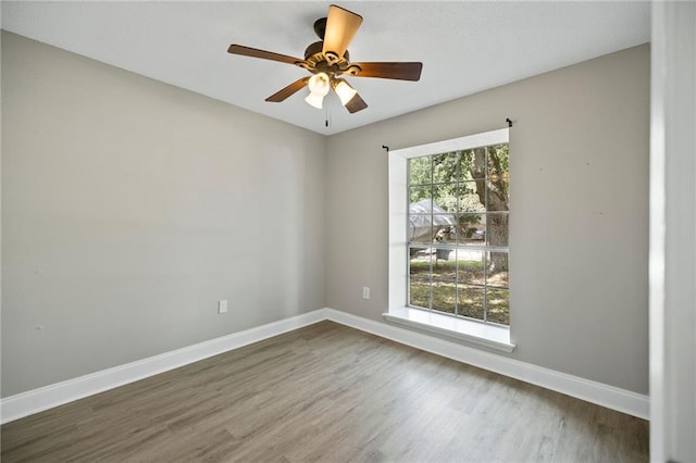 empty room featuring hardwood / wood-style floors and ceiling fan