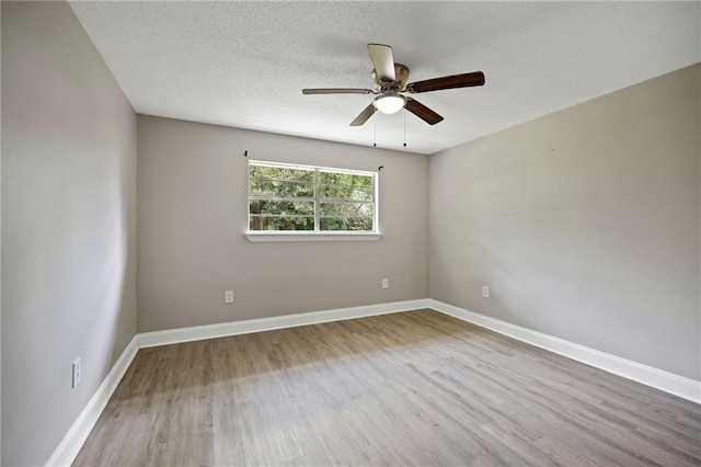 unfurnished room with ceiling fan, a textured ceiling, and light hardwood / wood-style flooring