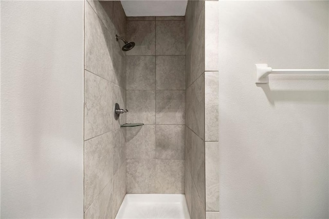 bathroom with tiled shower