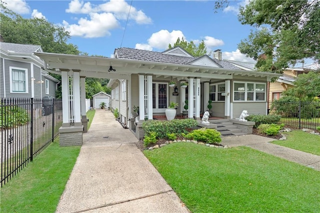 view of front facade featuring a garage, an outdoor structure, fence, and a front yard