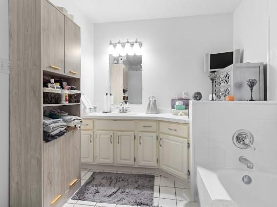 bathroom featuring a tub, vanity, and tile patterned floors