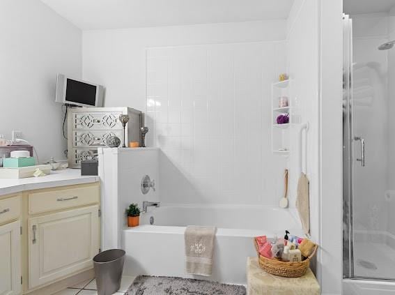 bathroom featuring tile patterned flooring, vanity, and plus walk in shower