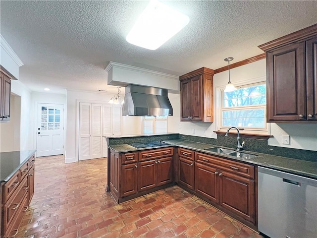 kitchen with pendant lighting, crown molding, stainless steel dishwasher, sink, and wall chimney range hood