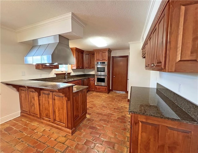 kitchen with crown molding, wall chimney exhaust hood, kitchen peninsula, and stainless steel double oven