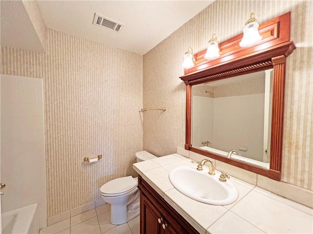 full bathroom with tile patterned floors, toilet, shower with separate bathtub, and vanity