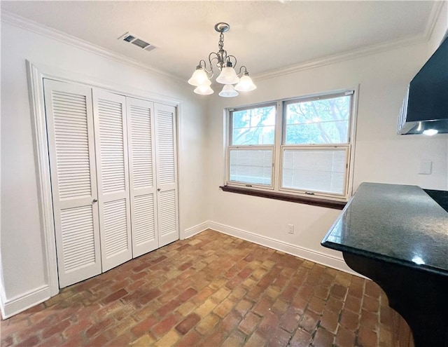 dining space featuring ornamental molding and a chandelier