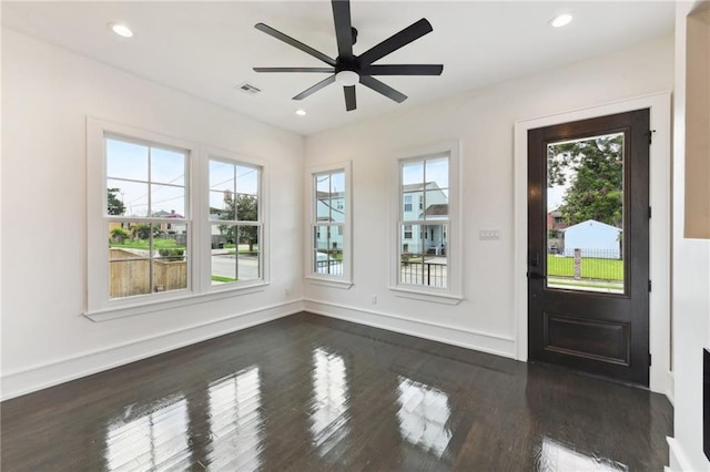 foyer entrance with ceiling fan and dark hardwood / wood-style floors