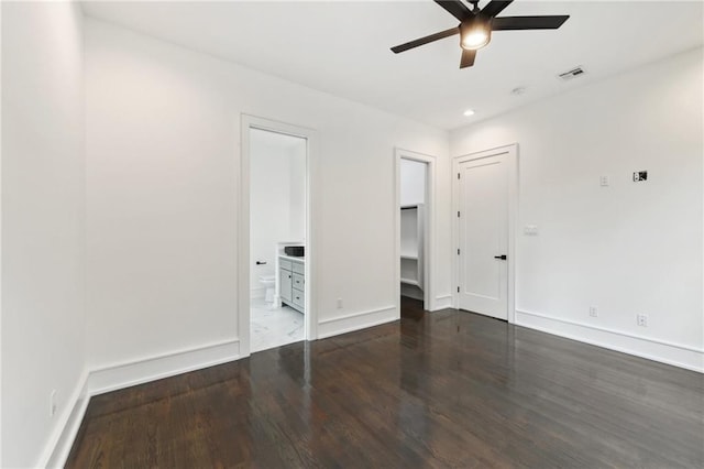 unfurnished bedroom with ensuite bath, ceiling fan, and dark hardwood / wood-style floors