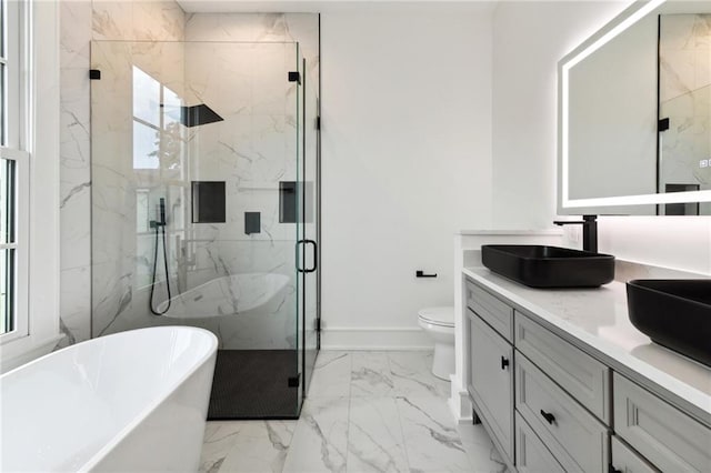 full bathroom featuring a wealth of natural light, shower with separate bathtub, toilet, and vanity