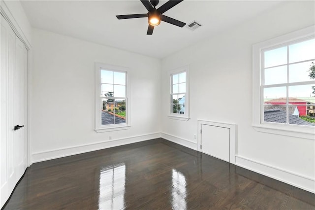 unfurnished room featuring ceiling fan and dark hardwood / wood-style floors