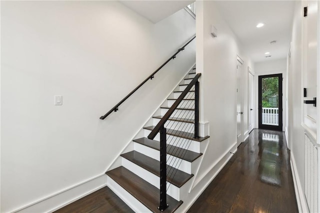 stairway with hardwood / wood-style floors