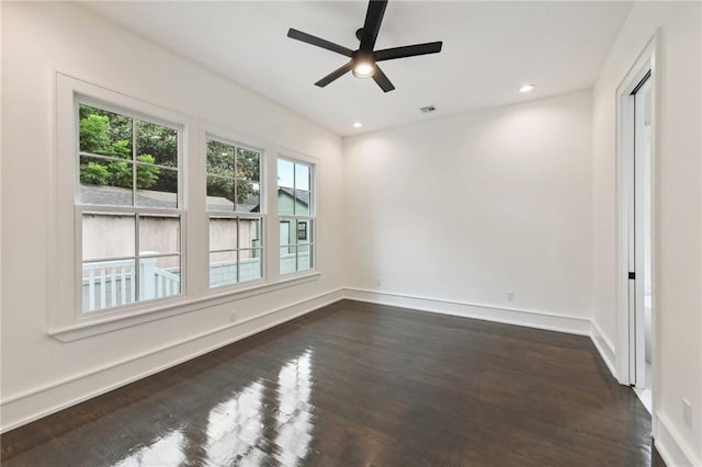 spare room featuring ceiling fan and dark hardwood / wood-style flooring