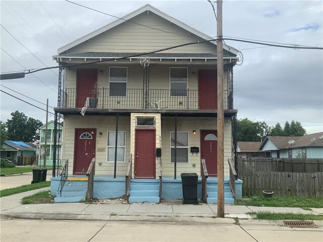 2351 S Derbigny St, New Orleans, LA 70125 - view of front of property with a balcony, a porch, and fence