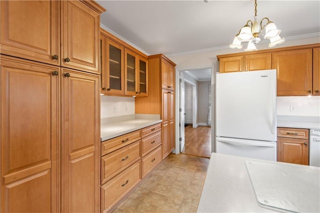 kitchen with crown molding, white refrigerator, a chandelier, and hanging light fixtures